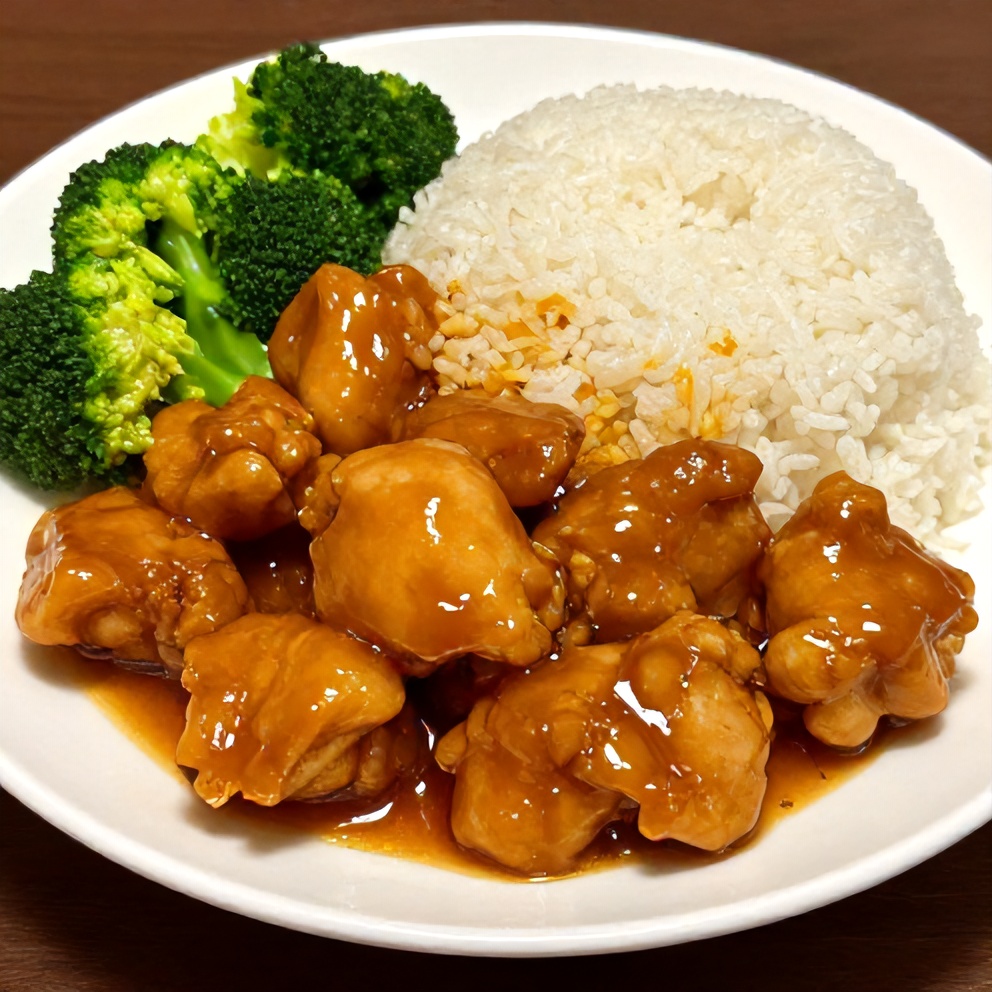 Plated serving of orange chicken with steamed rice and broccoli