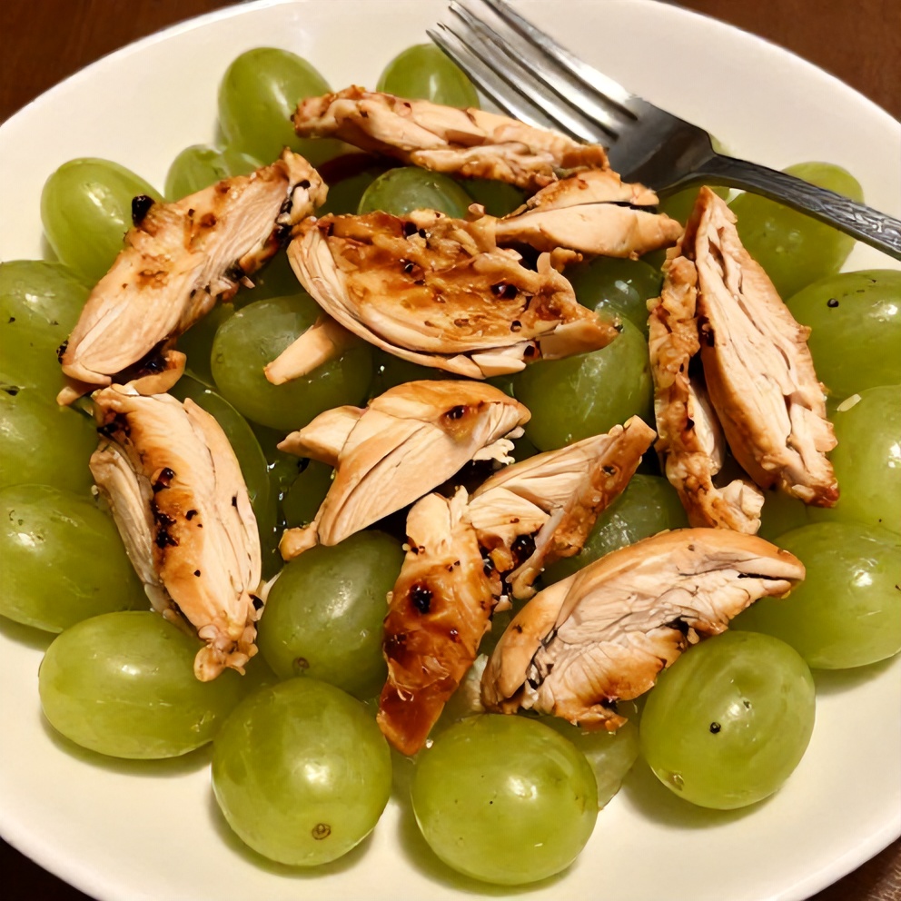 Plated chicken grape salad with a fork