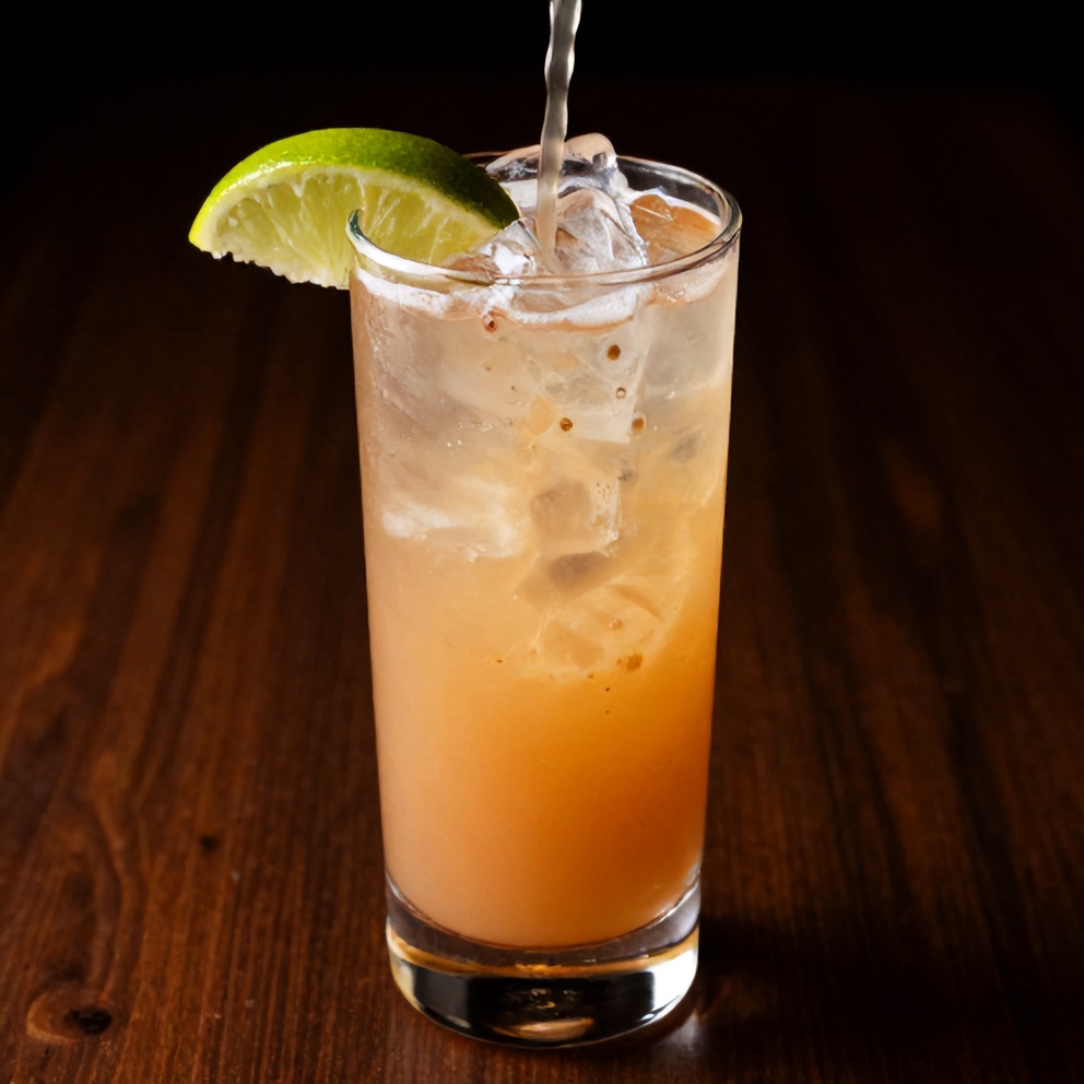 Raspberry Passionfruit Tequila Sour cocktail poured into a glass with a lime wheel garnish