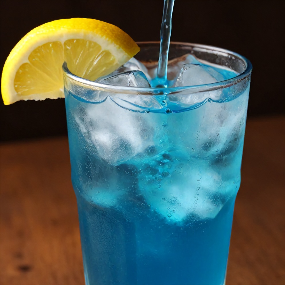 Blueberry syrup poured over ice in a glass