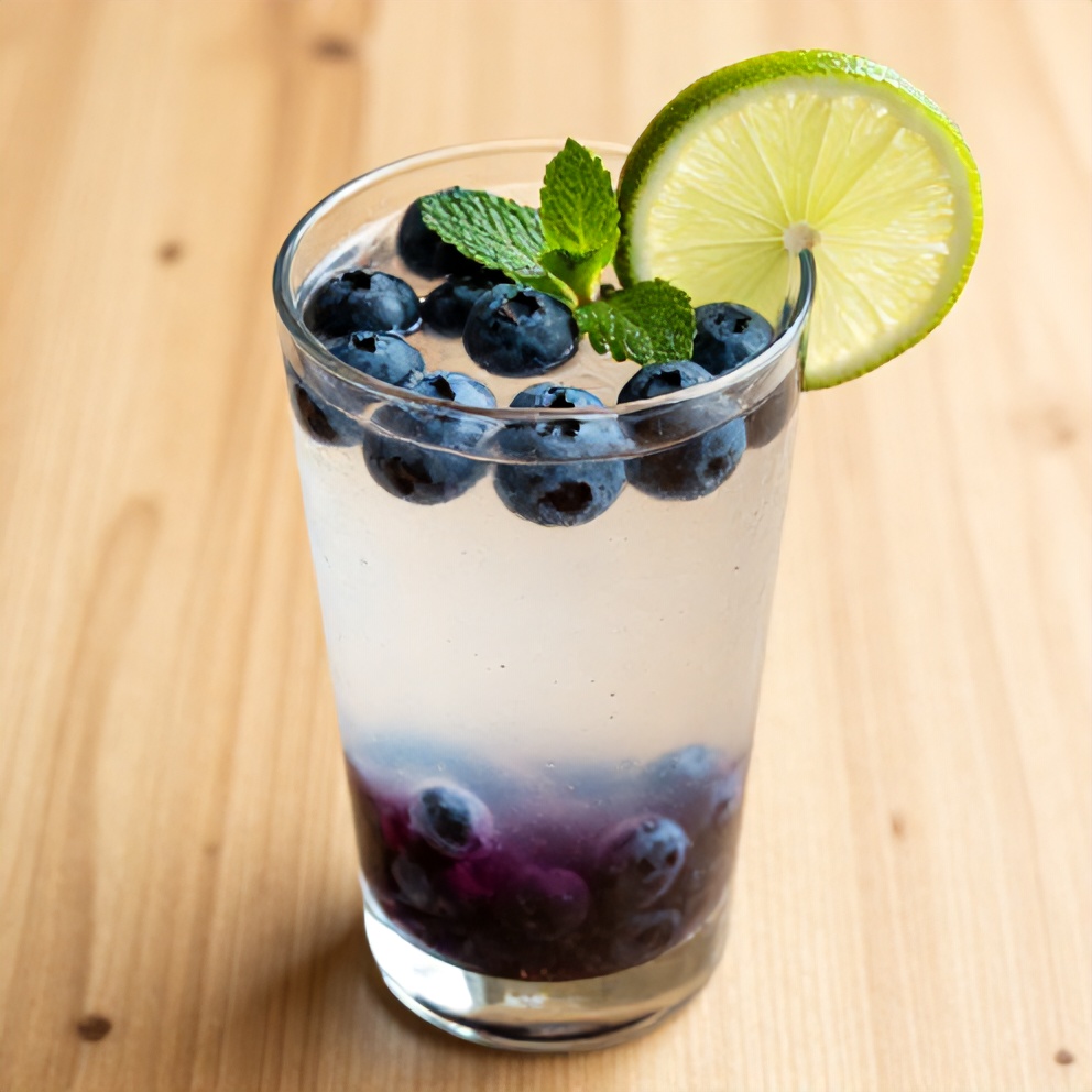 Blueberry Coconut Water Drink garnished with lime and mint