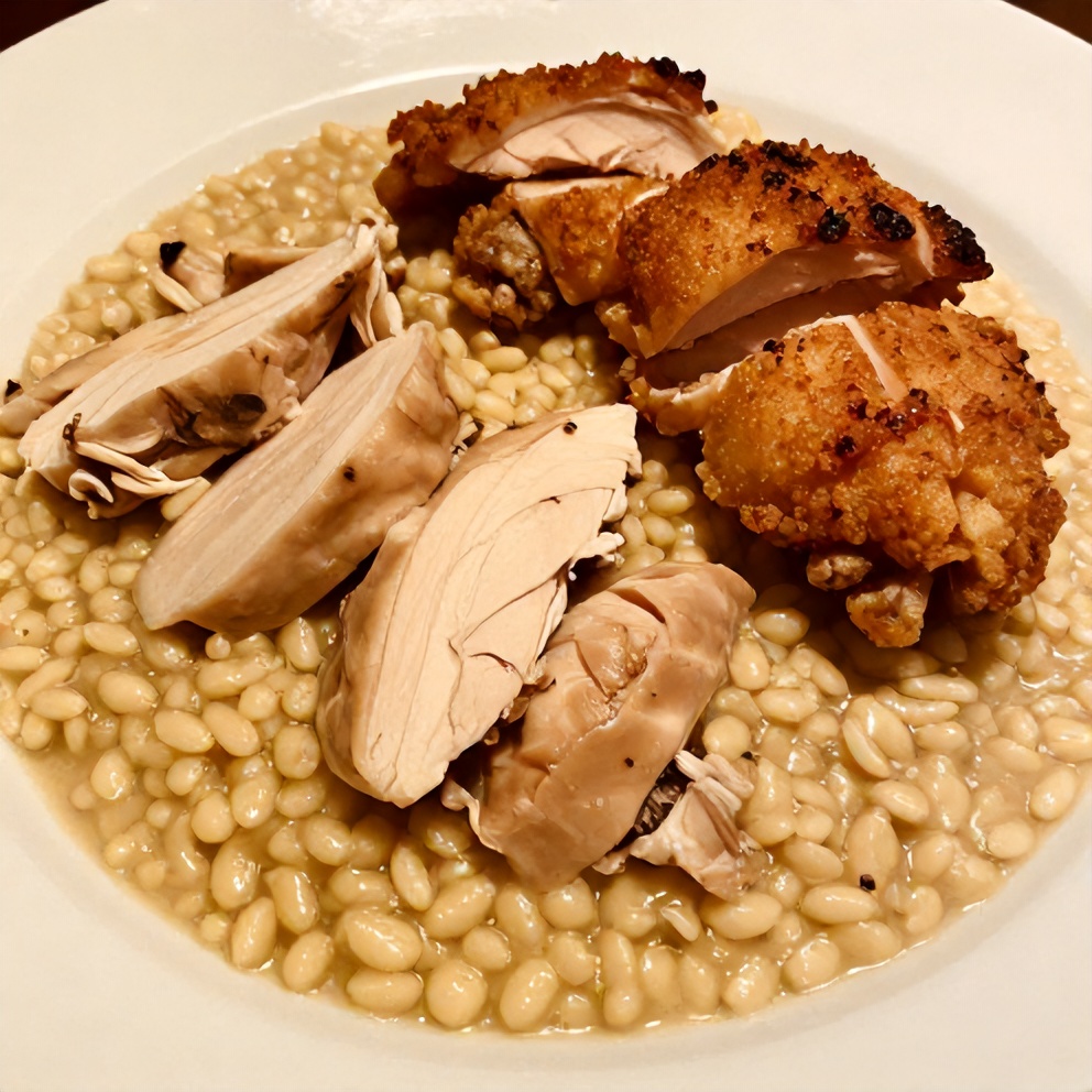 Plated serving of slow cooker parmesan herb chicken with creamy orzo