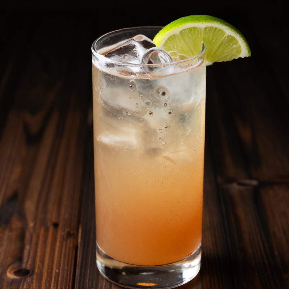 Keto Hibiscus Lime Sparkling Water poured into a glass with ice and a lime wedge